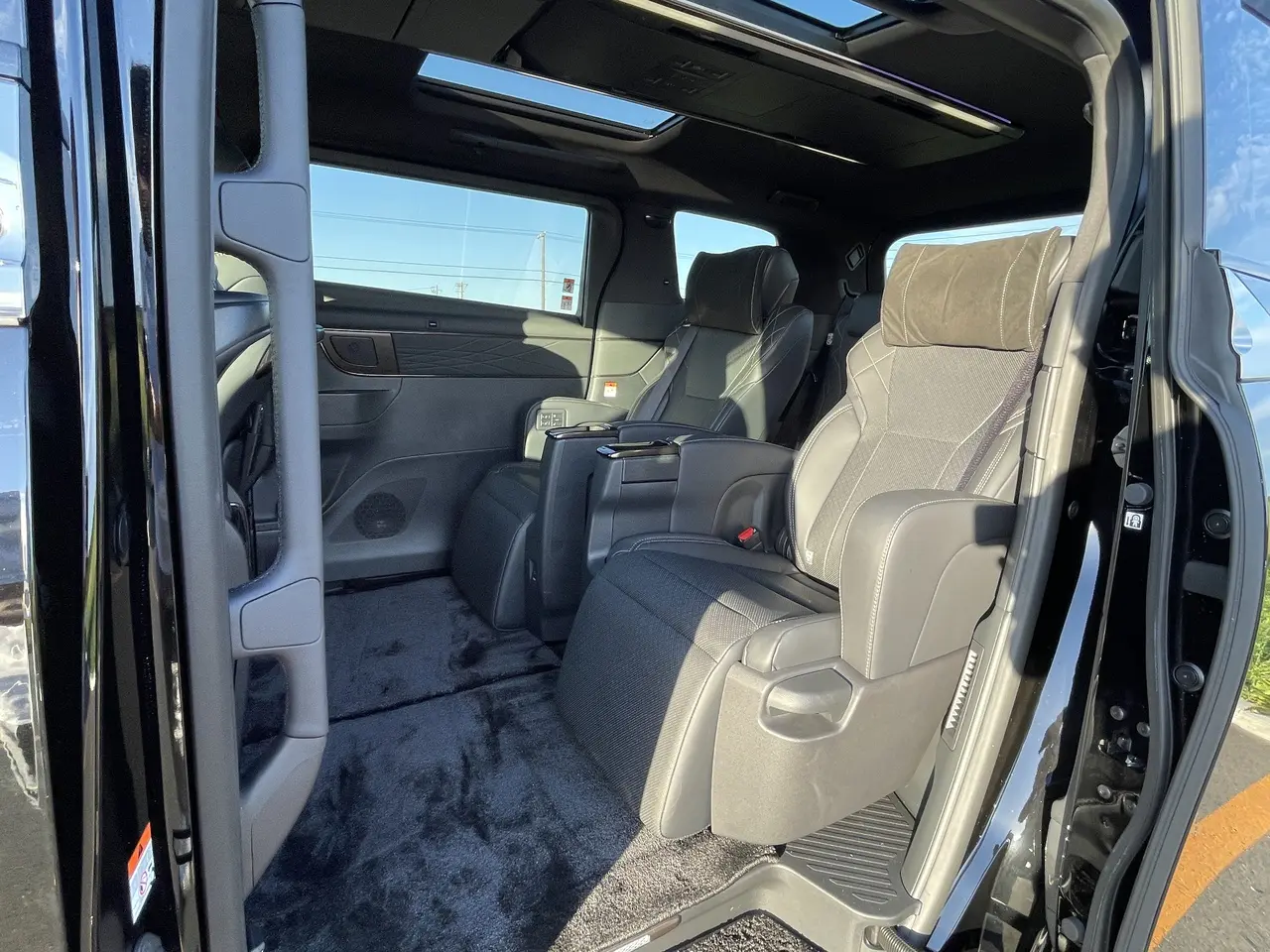 Image of a mobile office space inside a spacious Alphard or Vellfire where passengers can work during travel